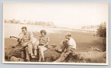 Vintage Photo People Sitting on a Log and Drinking Moonshine from a Jar